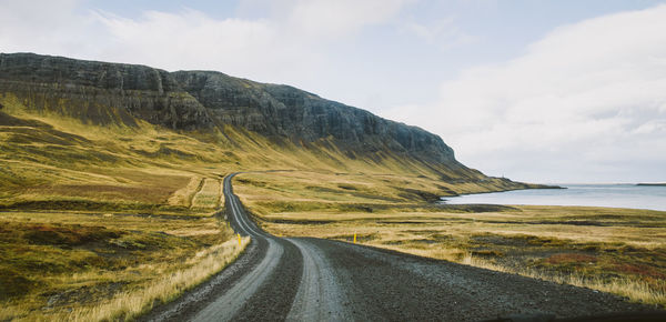 Road by sea against sky