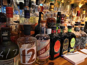 Various bottles on shelf at market stall