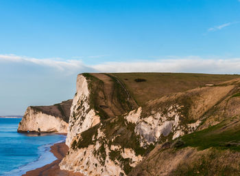 Scenic view of sea against sky with durdle door cliffs in the foreground