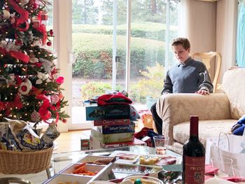 Boy sitting on chair at home during christmas