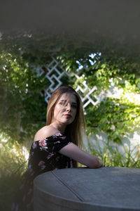 Portrait of a young woman sitting outdoors