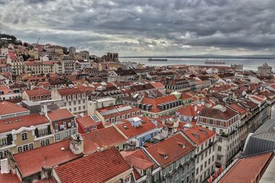 High angle view of townscape by sea against sky