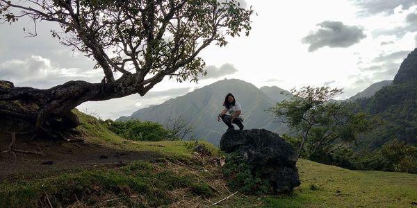 Man standing on mountain against sky