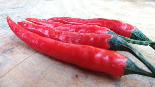 Close-up of red chili peppers on table