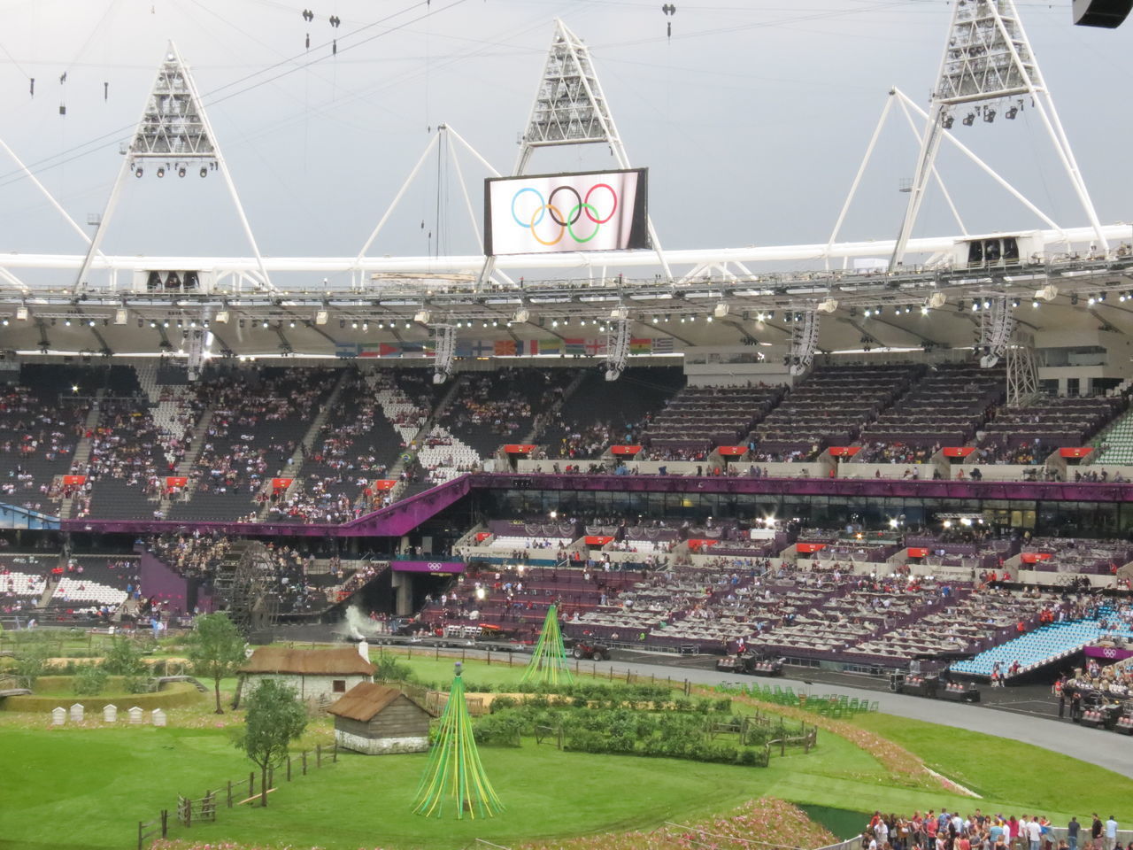 HIGH ANGLE VIEW OF CROWD ON FIELD AGAINST SKY