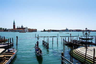 High angle view of gondola boat moving on river against clear sky