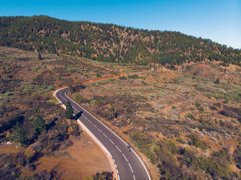 High angle view of road amidst trees against sky