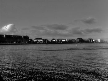 View of calm sea with buildings in background