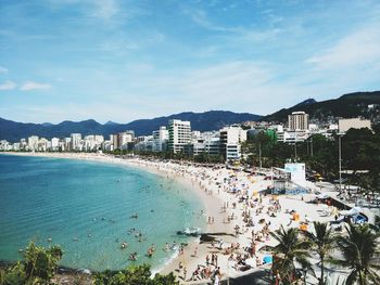 High angle view of people at beach against sky in city