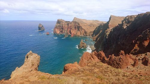 Panoramic view of sea and mountains against sky