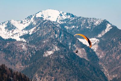 People skiing on mountain against sky