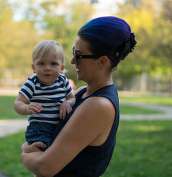 Portrait aunt and son standing outdoors