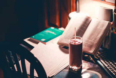 High angle view of drink on table by a book