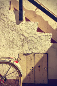 Close-up of bicycle against wall