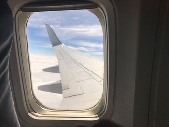 View of airplane wing seen through window