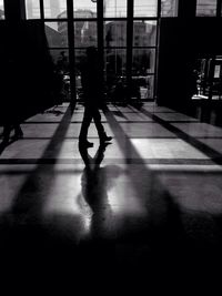 Shadow of woman on city street