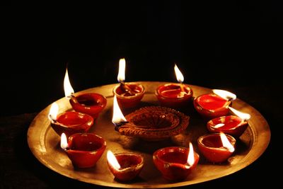 Close-up of lit candles on table