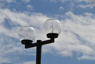 Low angle view of street light against sky