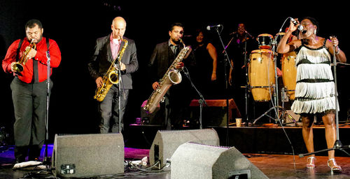 Panoramic view of people playing at music concert