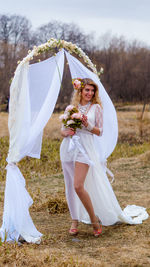 Full length of bride standing on field