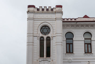 Low angle view of clock tower against sky