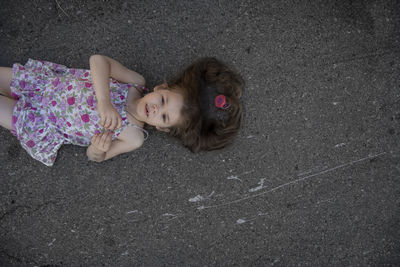 High angle view portrait of cute girl lying down on woman