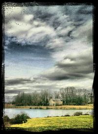 Scenic view of lake against cloudy sky
