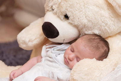 Cute baby girl sleeping on bed