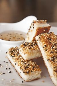 High angle view of fried breadsticks covered with sesame seeds