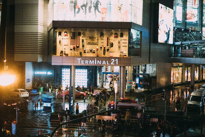 Group of people on illuminated building at night