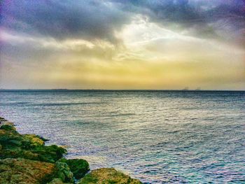 Scenic view of sea against cloudy sky