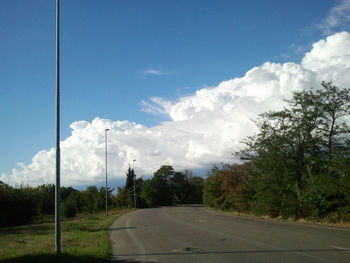 Empty road against cloudy sky