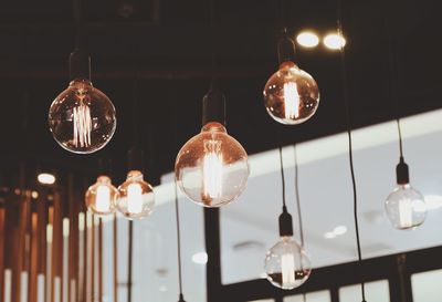 Low angle view of illuminated light bulbs