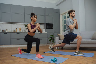 Full length of woman exercising in gym