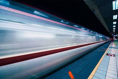 Blurred motion of train on railroad station platform