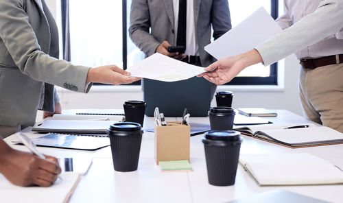 Midsection of business colleagues shaking hands