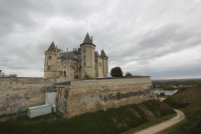 Historic building against cloudy sky