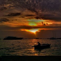 Boat sailing in sea during sunset