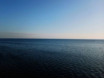 Scenic view of sea against clear sky at sunset