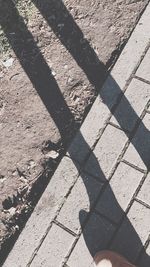 Shadow of people on footpath