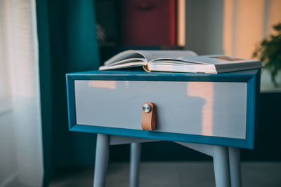 Close-up of open book on table at home