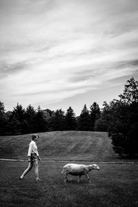 Woman with dog on field