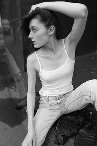 Portrait of young woman sitting outdoors