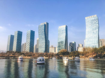 Autumn in central park of incheon city. high buildings under a lake. south korea