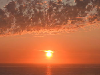 Scenic view of sea against romantic sky at sunset