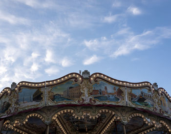 Low angle view of carousel against sky