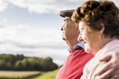 Senior couple embracing in rural landscape