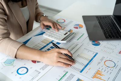 Midsection of business people working at office