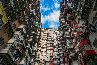 Low angle view of residential building against cloudy sky