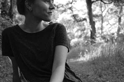 Smiling woman looking away in forest